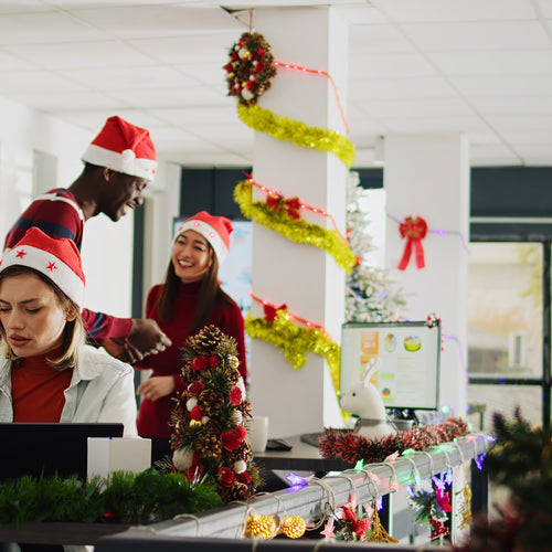 People at work in an office decorated for Christmas