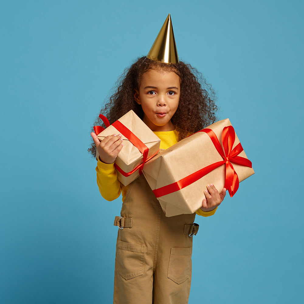 Unique Personalised Gifts For Children category image showing a little girl holding a gift box