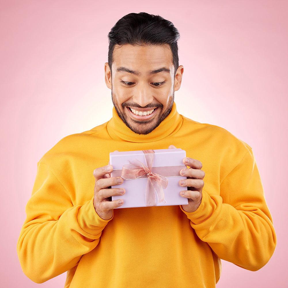 Unique Personalised Gifts For Him category image showing a man holding a gift box